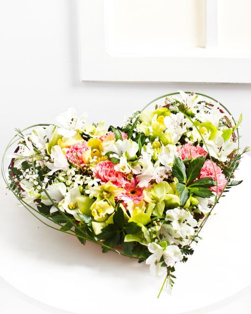 Heart-shaped flower arrangement in light colours